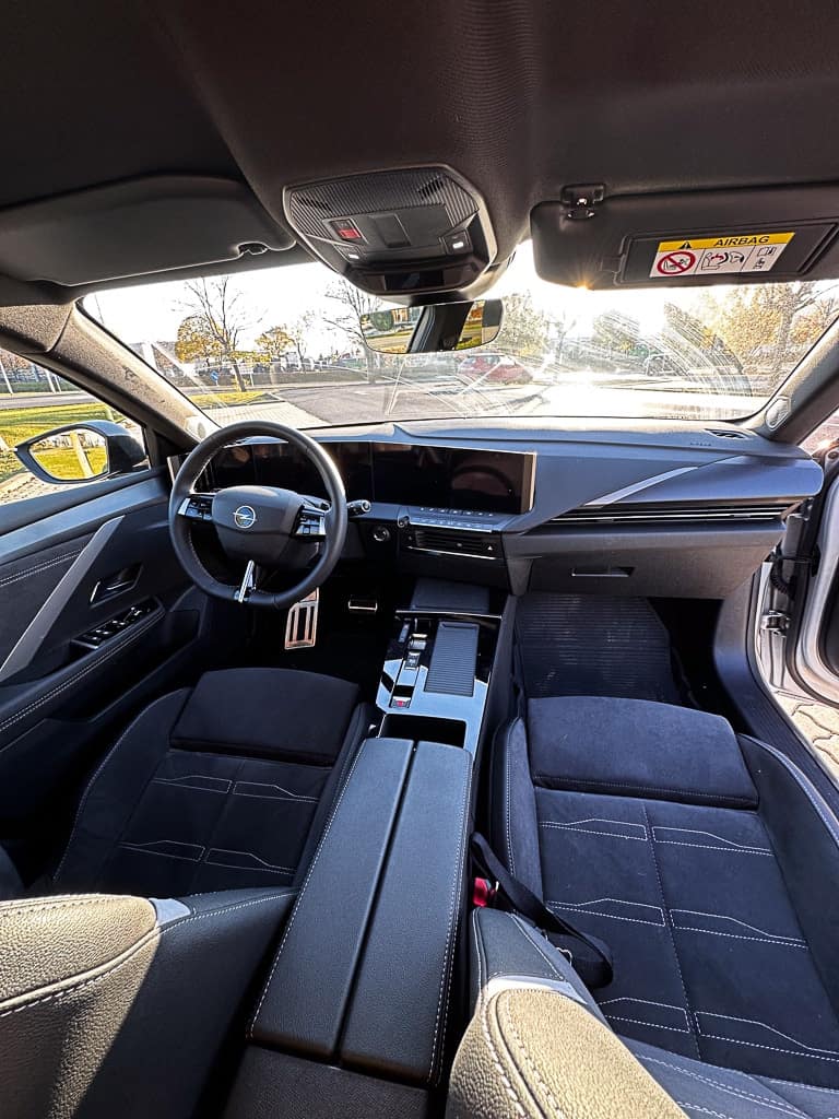 Innenraumansicht eines Autos mit einem eleganten Armaturenbrett, einem multifunktionalen Lenkrad und komfortablen Sitzen, die ein luxuriöses Fahrerlebnis versprechen